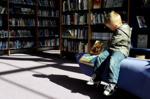 child sitting in the library