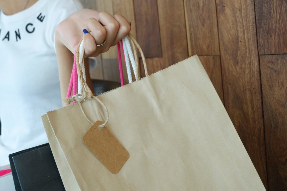 A girl holding shopping bags.