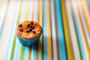 A muffin on a colorful surface