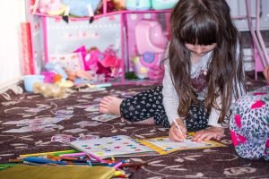 Little girl playing in her room.
