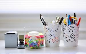 Office desk with different office supplies is an important part of commercial relocation checklist